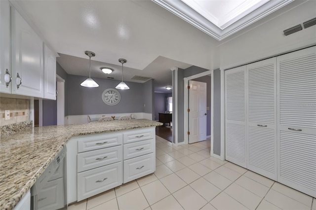 kitchen featuring white cabinets, crown molding, kitchen peninsula, and hanging light fixtures