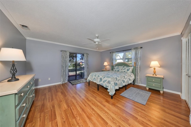 bedroom featuring access to exterior, ceiling fan, a closet, and ornamental molding