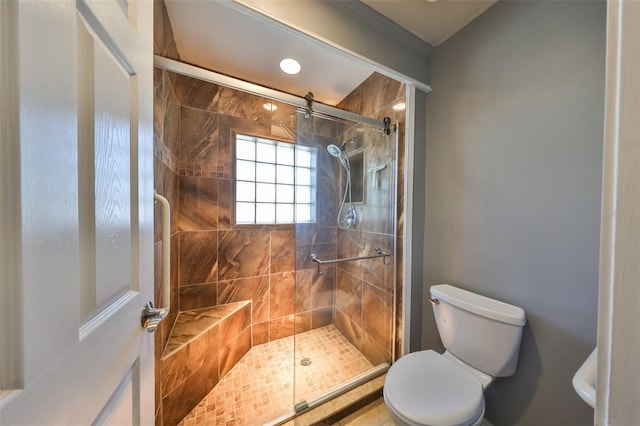 bathroom featuring toilet and an enclosed shower