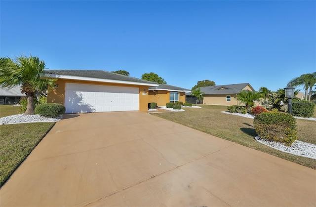 ranch-style house featuring a front yard and a garage