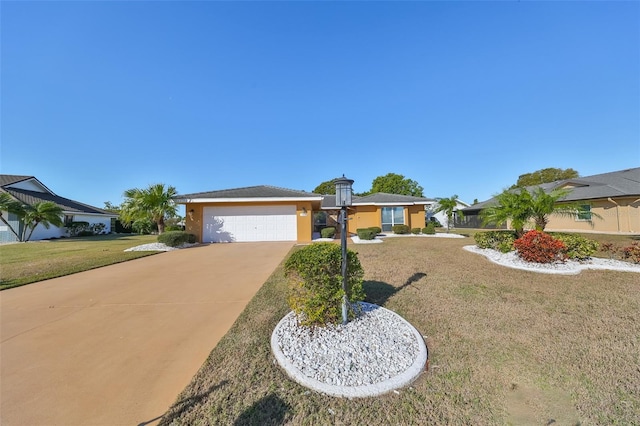 single story home featuring a garage and a front lawn