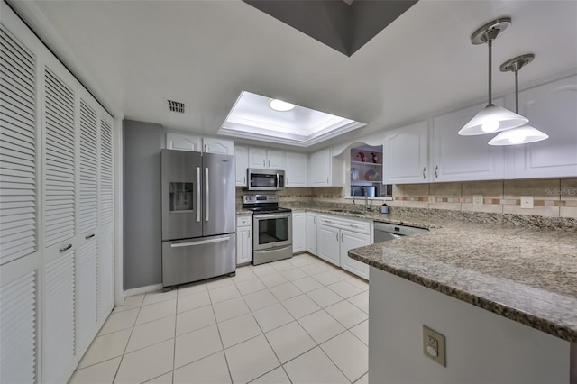 kitchen featuring pendant lighting, decorative backsplash, white cabinets, and stainless steel appliances