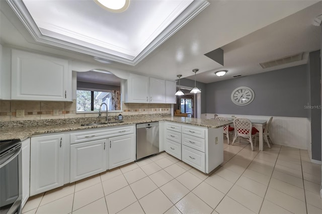 kitchen featuring dishwasher, sink, kitchen peninsula, tasteful backsplash, and white cabinetry