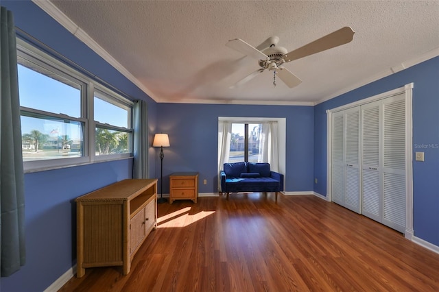 unfurnished room with ceiling fan, dark wood-type flooring, and ornamental molding