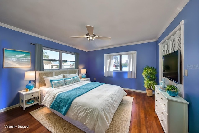 bedroom featuring dark hardwood / wood-style flooring, ceiling fan, and ornamental molding