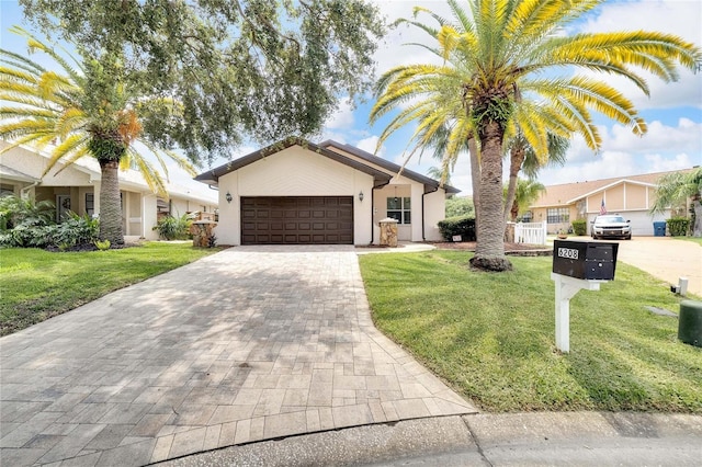 view of front of house with a garage and a front lawn