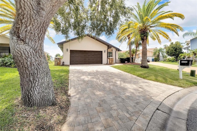 view of front facade featuring a garage and a front lawn