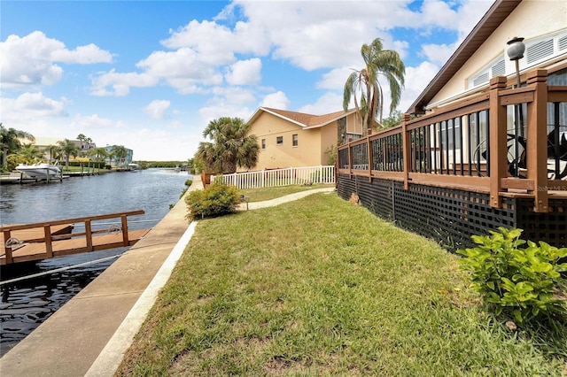 view of yard featuring a water view and a dock