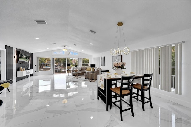 dining area featuring lofted ceiling, a wealth of natural light, and a textured ceiling