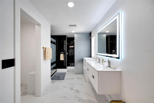 bathroom with vanity and a shower