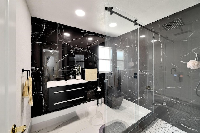 bathroom with vanity and a shower with shower door