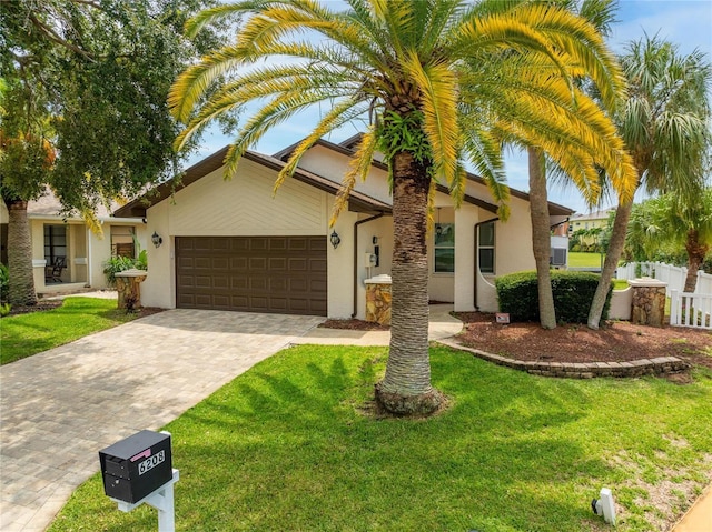 view of front of house featuring a garage and a front yard