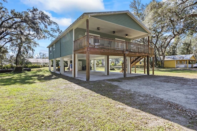 exterior space featuring a patio area, ceiling fan, a yard, and a deck