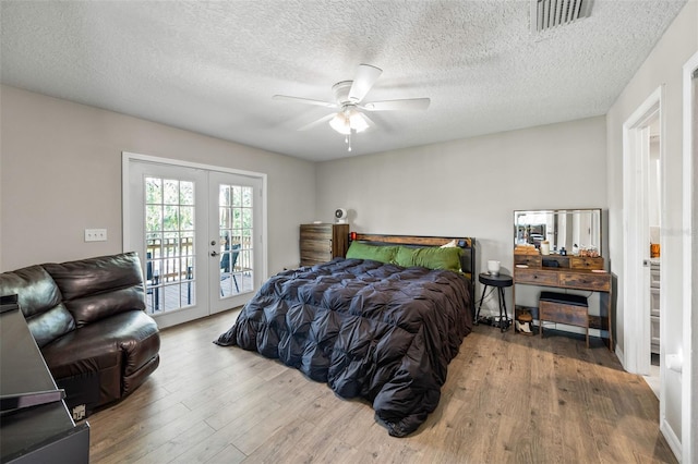 bedroom with access to outside, ceiling fan, french doors, and light hardwood / wood-style floors