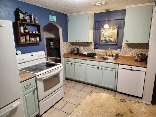 kitchen featuring backsplash, white appliances, a textured ceiling, sink, and pendant lighting