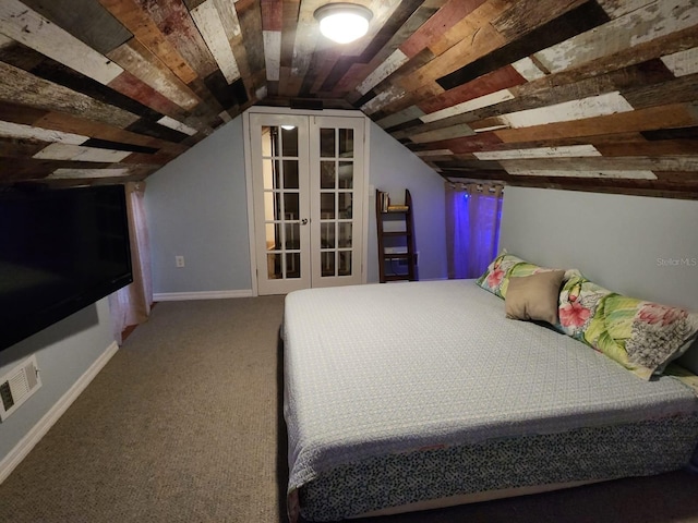 carpeted bedroom with vaulted ceiling and french doors