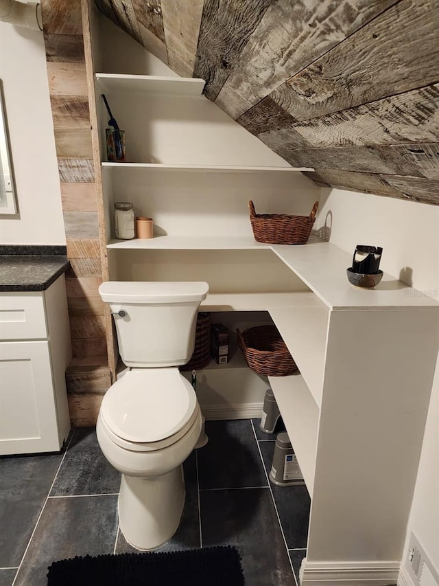 bathroom with tile patterned flooring, vanity, and toilet