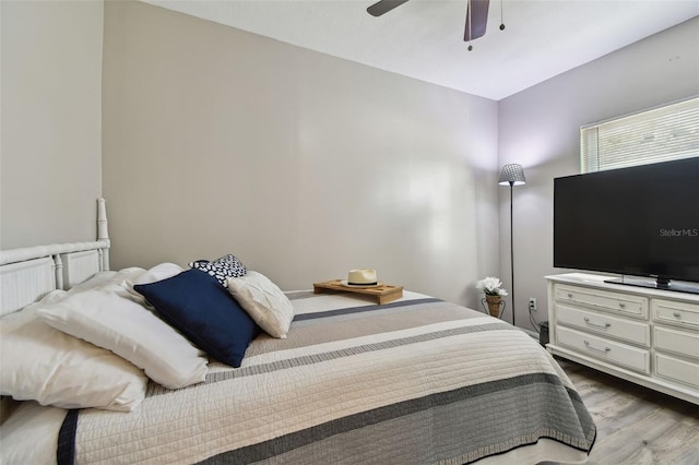 bedroom with ceiling fan and light hardwood / wood-style floors