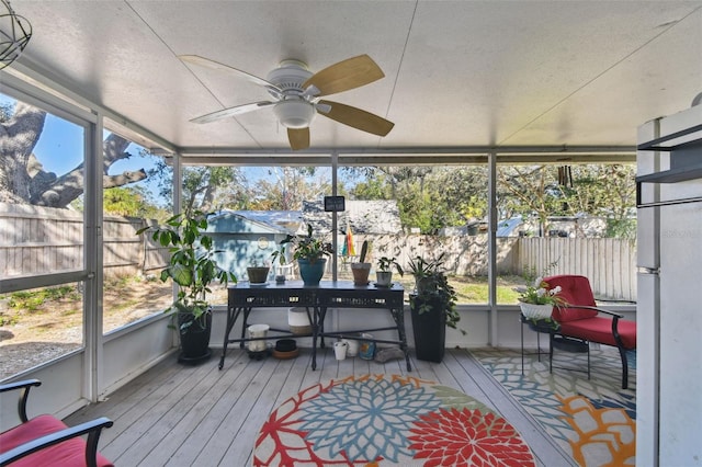 sunroom featuring ceiling fan