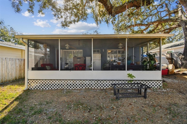 rear view of house featuring a sunroom