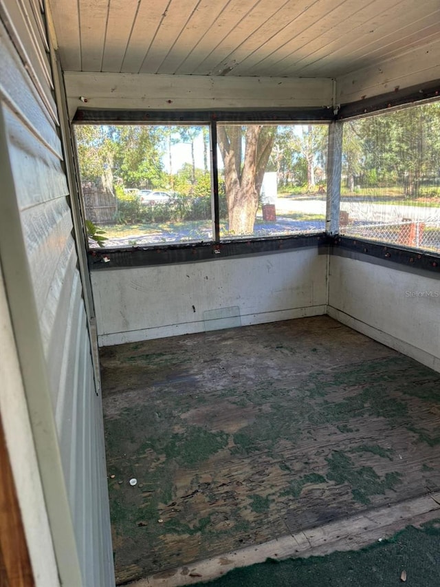 unfurnished sunroom with wood ceiling and a wealth of natural light