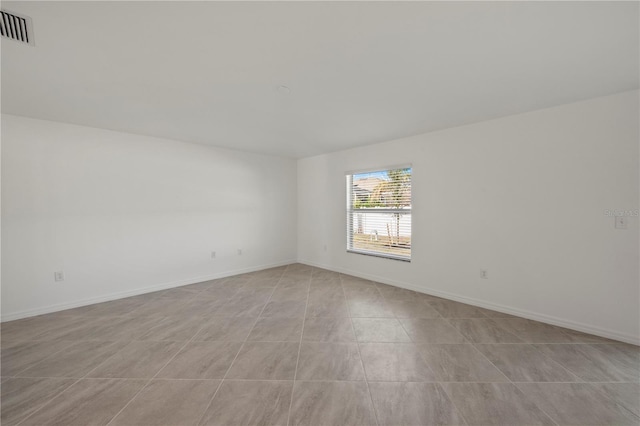 empty room with light tile patterned floors