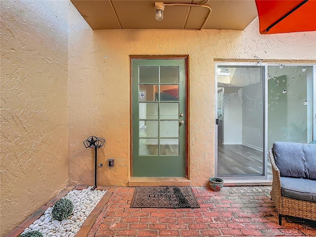 entrance to property with a patio