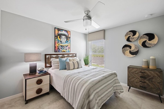 tiled bedroom featuring ceiling fan