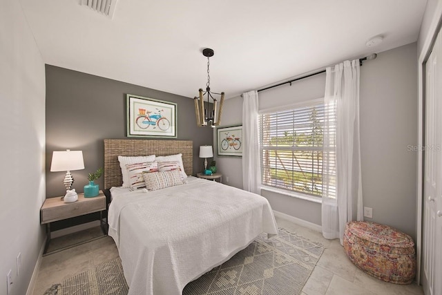 bedroom featuring a closet and an inviting chandelier