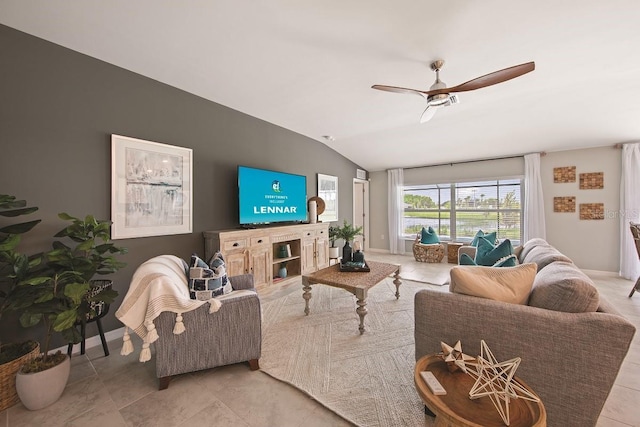 living room with ceiling fan, light tile patterned flooring, and lofted ceiling