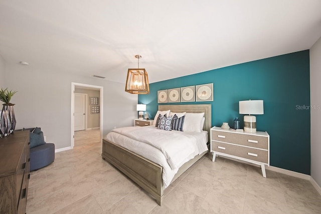 bedroom with a notable chandelier