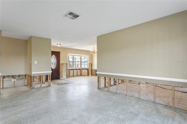 unfurnished room featuring a notable chandelier