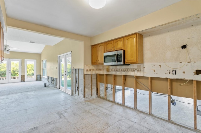 kitchen featuring ceiling fan, french doors, and vaulted ceiling