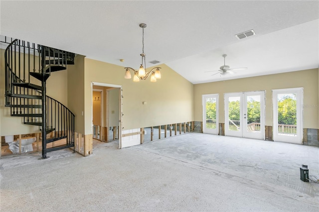 carpeted empty room featuring ceiling fan with notable chandelier and lofted ceiling