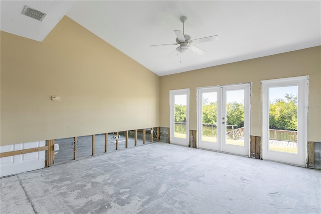 empty room with ceiling fan, lofted ceiling, and french doors