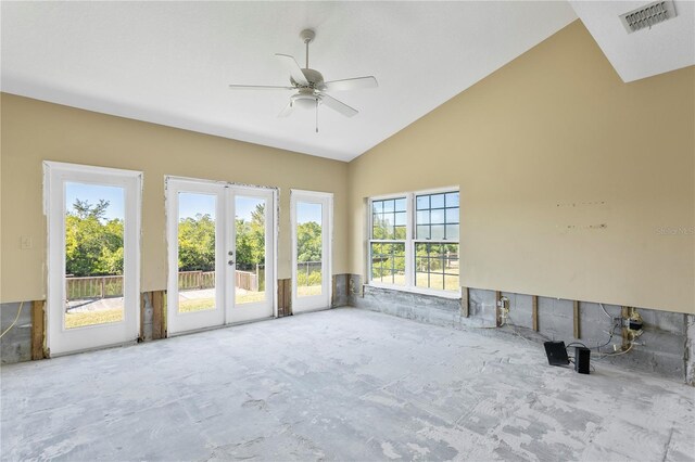 unfurnished sunroom featuring ceiling fan, french doors, and vaulted ceiling