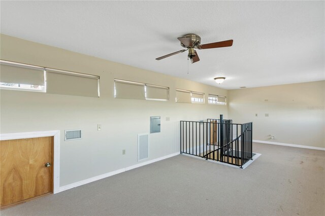 interior space with carpet flooring and ceiling fan