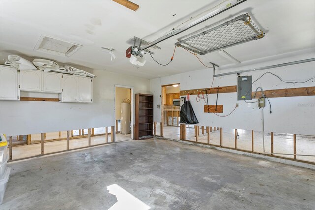 garage with electric panel, water heater, and a garage door opener