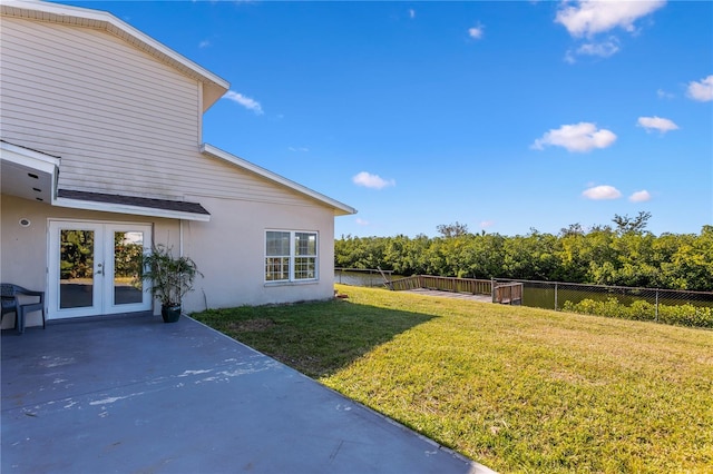 view of yard featuring a patio area and french doors