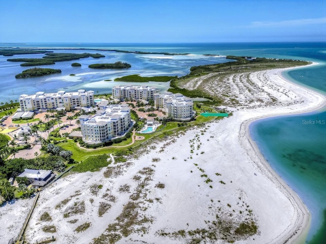 drone / aerial view featuring a water view and a beach view