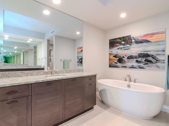 bathroom featuring a tub and vanity