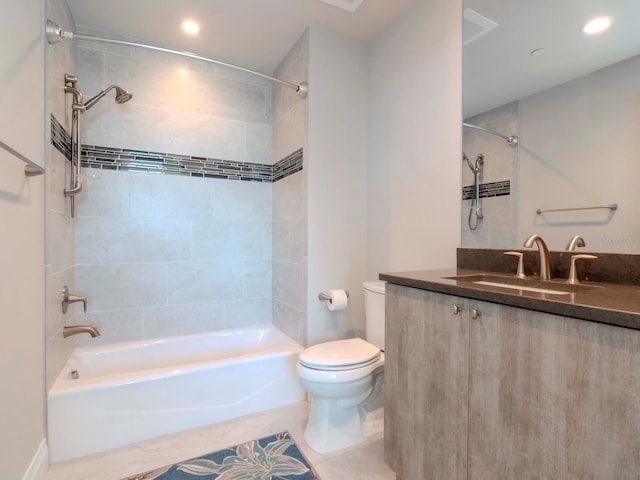 full bathroom with tile patterned flooring, vanity, toilet, and tiled shower / bath