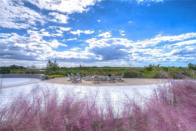 property view of water featuring an outdoor fire pit