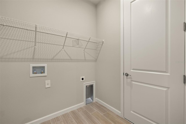 laundry room featuring hookup for a washing machine, hookup for an electric dryer, and light wood-type flooring