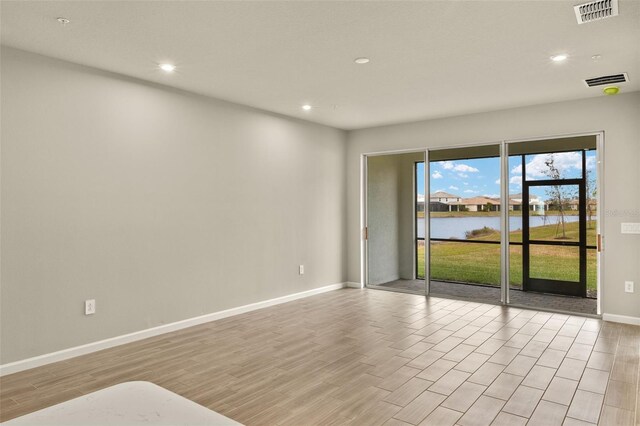 empty room with a water view and light wood-type flooring