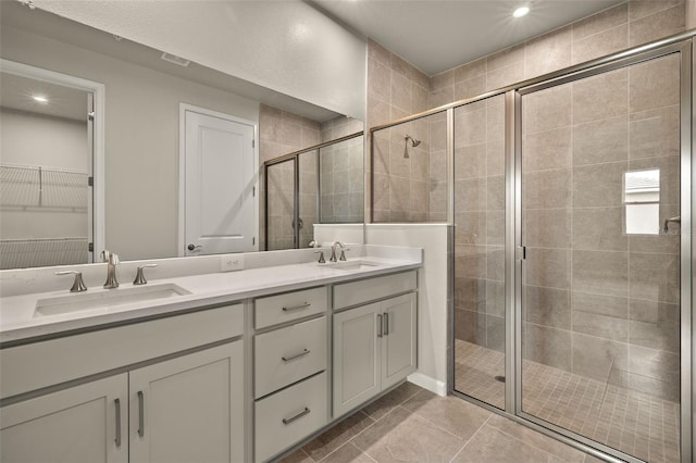 bathroom featuring vanity, tile patterned flooring, and a shower with door