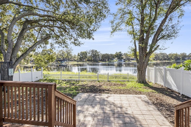 deck featuring a water view and a patio