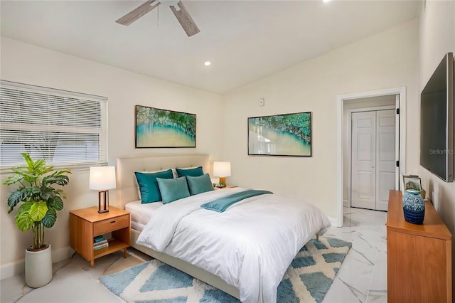 bedroom featuring vaulted ceiling, marble finish floor, a ceiling fan, and baseboards