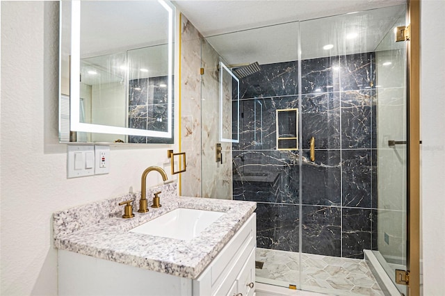 bathroom featuring a stall shower and vanity