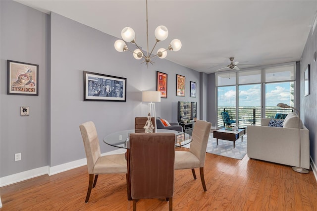 1120 E Kennedy Blvd Unit 1221, Tampa, FL 33602 - dining area featuring floor to ceiling windows, light wood-style floors, ceiling fan, and a chandelier